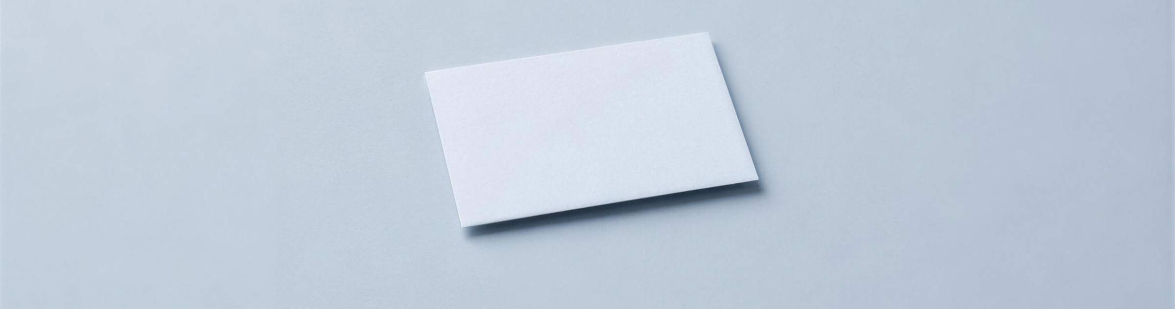 A single blank card lying on a pale surface.